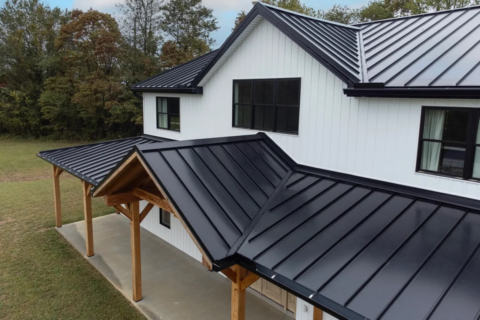 Black metal roofing on a white building.